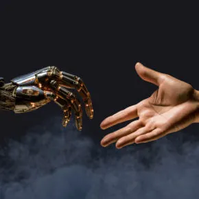 A robotic hand reaching out to a human hand.