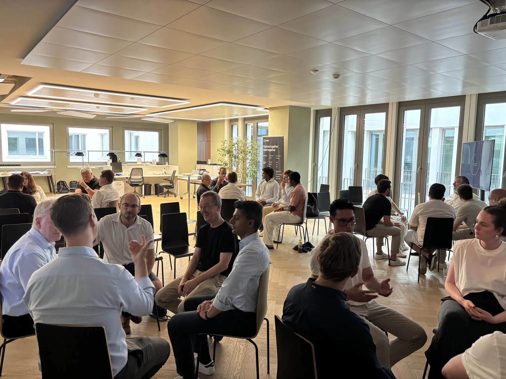 People engaging in a group discussion during a business workshop in a modern office setting.